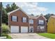 Charming two-story brick home featuring an attached two-car garage and well-manicured lawn at 2379 Fallbrook Ct, Duluth, GA 30096