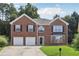 Charming two-story brick home featuring an attached two-car garage and well-manicured lawn at 2379 Fallbrook Ct, Duluth, GA 30096
