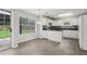 Bright kitchen with white cabinetry, dark countertops, a view of the backyard and laminate flooring at 2379 Fallbrook Ct, Duluth, GA 30096