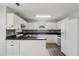 Bright kitchen featuring white cabinetry, dark countertops and backsplash, and stainless-steel appliances at 2379 Fallbrook Ct, Duluth, GA 30096