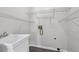Convenient laundry room with utility sink, laminate flooring, and wire shelving for storage at 2379 Fallbrook Ct, Duluth, GA 30096