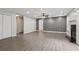 Spacious living room featuring laminate floors, neutral colors, a fireplace, and ample natural light at 2379 Fallbrook Ct, Duluth, GA 30096