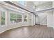 Open living room with large windows, hardwood floors, high ceilings, and modern lighting at 2379 Fallbrook Ct, Duluth, GA 30096