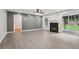 Spacious living room featuring laminate floors, neutral colors, a fireplace, and a sliding glass door at 2379 Fallbrook Ct, Duluth, GA 30096
