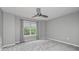 Gray carpeted bedroom features a double window with curtains and a ceiling fan at 2680 Pine Tree Ne Rd # 2, Atlanta, GA 30324