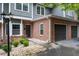 Detail of townhome with brick accents, a two-car garage, and a landscaped front yard at 2680 Pine Tree Ne Rd # 2, Atlanta, GA 30324