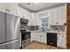 Well-lit kitchen with stainless steel appliances and white cabinetry at 2680 Pine Tree Ne Rd # 2, Atlanta, GA 30324