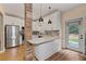 Bright kitchen featuring white cabinets, stainless steel appliances, and an adjacent door to the backyard at 2680 Pine Tree Ne Rd # 2, Atlanta, GA 30324