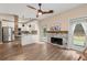 Open concept living space, featuring a modern kitchen, decorative fireplace, and access to outdoor at 2680 Pine Tree Ne Rd # 2, Atlanta, GA 30324
