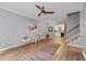 Bright living room with wood floors, ceiling fan, stairs, and view into the kitchen at 2680 Pine Tree Ne Rd # 2, Atlanta, GA 30324