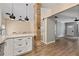 Open-concept living space featuring updated floors, bright white kitchen and stylish barn door at 2680 Pine Tree Ne Rd # 2, Atlanta, GA 30324