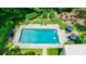 This aerial view showcases an in-ground pool with a patio, lounge chairs, and beautifully maintained greenery at 510 Heards Ferry Rd, Atlanta, GA 30328