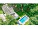 This aerial view displays the home with an in-ground pool, patio, landscaped yard, and a charming roof at 510 Heards Ferry Rd, Atlanta, GA 30328