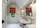 Unique bathroom with a vintage-style double sink vanity and plaid window shade at 510 Heards Ferry Rd, Atlanta, GA 30328