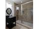 Bathroom features a black vanity with a framed mirror and a large walk-in shower with glass doors and decorative tile at 510 Heards Ferry Rd, Atlanta, GA 30328