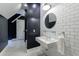 Modern bathroom with white subway tiles, a sleek black accent wall, and a floating sink at 510 Heards Ferry Rd, Atlanta, GA 30328