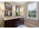 Elegant bathroom with double sinks, a marble countertop, and natural light from the window at 510 Heards Ferry Rd, Atlanta, GA 30328