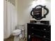 Bathroom features a black vanity with a framed mirror, a toilet, and a shower with a white curtain at 510 Heards Ferry Rd, Atlanta, GA 30328