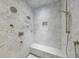 Modern bathroom featuring a marble-tiled shower, built-in bench, and sleek fixtures at 510 Heards Ferry Rd, Atlanta, GA 30328