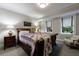 Bedroom features a queen-sized bed with a decorative quilt, two windows for natural light, and neutral paint at 510 Heards Ferry Rd, Atlanta, GA 30328