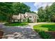 Charming two-story home with well-kept lawn, circular driveway, and lush landscaping at 510 Heards Ferry Rd, Atlanta, GA 30328