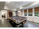 Bright game room showcases a pool table, recessed lighting, and large windows with views of the property's lush greenery at 510 Heards Ferry Rd, Atlanta, GA 30328