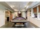 Spacious game room features a pool table, recessed lighting, and large windows with views of the property's lush greenery at 510 Heards Ferry Rd, Atlanta, GA 30328