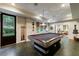Bright game room features a pool table, recessed lighting, and a door to the outside to a lush backyard at 510 Heards Ferry Rd, Atlanta, GA 30328