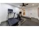Home gym features exercise equipment, neutral paint, a ceiling fan, and double doors leading to other parts of the home at 510 Heards Ferry Rd, Atlanta, GA 30328
