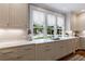 Elegant kitchen features marble countertops, custom cabinets, and a view of the outdoors at 510 Heards Ferry Rd, Atlanta, GA 30328