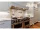 Chef's kitchen with stainless steel Wolf range, marble backsplash, and custom cabinetry at 510 Heards Ferry Rd, Atlanta, GA 30328
