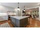 Gourmet kitchen features a marble island, stainless steel appliances, and adjacent living space at 510 Heards Ferry Rd, Atlanta, GA 30328