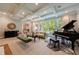 Sophisticated living room with large windows, coffered ceiling, and an elegant piano at 510 Heards Ferry Rd, Atlanta, GA 30328