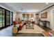 Spacious living room with a large sectional sofa, floor-to-ceiling doors, and ample natural light at 510 Heards Ferry Rd, Atlanta, GA 30328