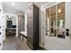 Inviting mudroom with custom built-ins, seating, storage, and beautiful stone floors leading to a sunroom at 510 Heards Ferry Rd, Atlanta, GA 30328
