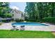 Inviting in-ground pool with lots of seating, surrounded by lush greenery at 510 Heards Ferry Rd, Atlanta, GA 30328