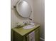 Charming powder room with a unique vanity, oval mirror, and soft striped wallpaper for a cozy feel at 510 Heards Ferry Rd, Atlanta, GA 30328