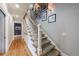Beautiful staircase featuring hardwood floors, patterned runner, and elegant picture gallery on the wall at 510 Heards Ferry Rd, Atlanta, GA 30328