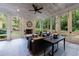 Bright sunroom with tiled floors, fireplace, ceiling fan, and wooded views offers relaxation at 510 Heards Ferry Rd, Atlanta, GA 30328