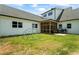 Expansive backyard with a sunroom addition, lush green lawn, and outdoor play equipment at 5315 Hendrix Rd, Cumming, GA 30040