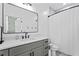 Modern bathroom features a sleek vanity, stylish mirror, and a shower with gray tiling at 5315 Hendrix Rd, Cumming, GA 30040