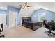This is a blue accent bedroom, featuring carpet, and a ceiling fan with plenty of natural light at 5315 Hendrix Rd, Cumming, GA 30040
