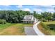 Beautiful aerial view of a modern farmhouse with a long driveway and expansive front yard at 5315 Hendrix Rd, Cumming, GA 30040