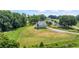 Aerial view of the home on a sprawling green lawn with mature trees and a long driveway at 5315 Hendrix Rd, Cumming, GA 30040