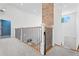 Upstairs hallway boasts views of the lower level with a decorative brick wall element at 5315 Hendrix Rd, Cumming, GA 30040