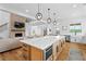 Modern kitchen view with an island, connecting to the living room and featuring lovely pendant lighting at 5315 Hendrix Rd, Cumming, GA 30040