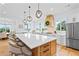 Spacious kitchen showcasing a large island, stylish pendant lighting, stainless steel appliances and scenic views at 5315 Hendrix Rd, Cumming, GA 30040