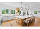 Well-lit kitchen featuring a large island with seating, stainless steel appliances, and verdant outdoor views at 5315 Hendrix Rd, Cumming, GA 30040