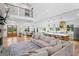 Bright, open-concept living room with fireplace, dining area, and a modern kitchen with an island and stainless steel appliances at 5315 Hendrix Rd, Cumming, GA 30040