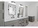 Bright bathroom showcasing dual sinks, stylish fixtures, grey cabinetry, and white hexagon tile flooring at 5315 Hendrix Rd, Cumming, GA 30040